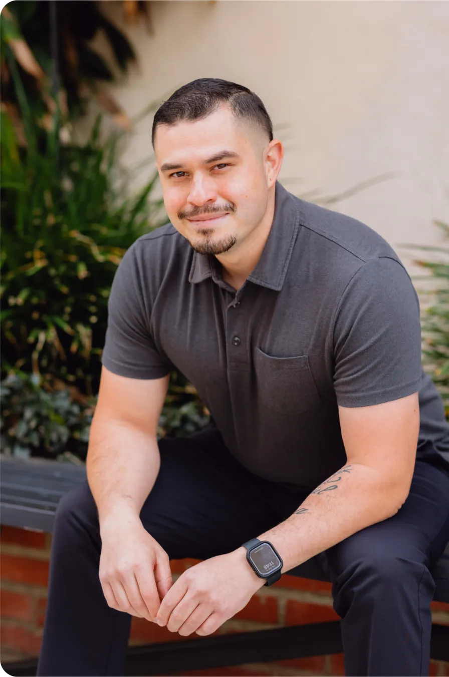 Portrait of a smiling man seated outdoors